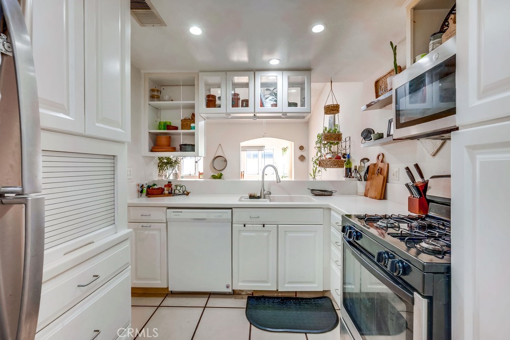 930 Countryside Street Hemet, CA 92545 - Photo 25 of 45 a kitchen with stainless steel appliances granite countertop a stove and a sink