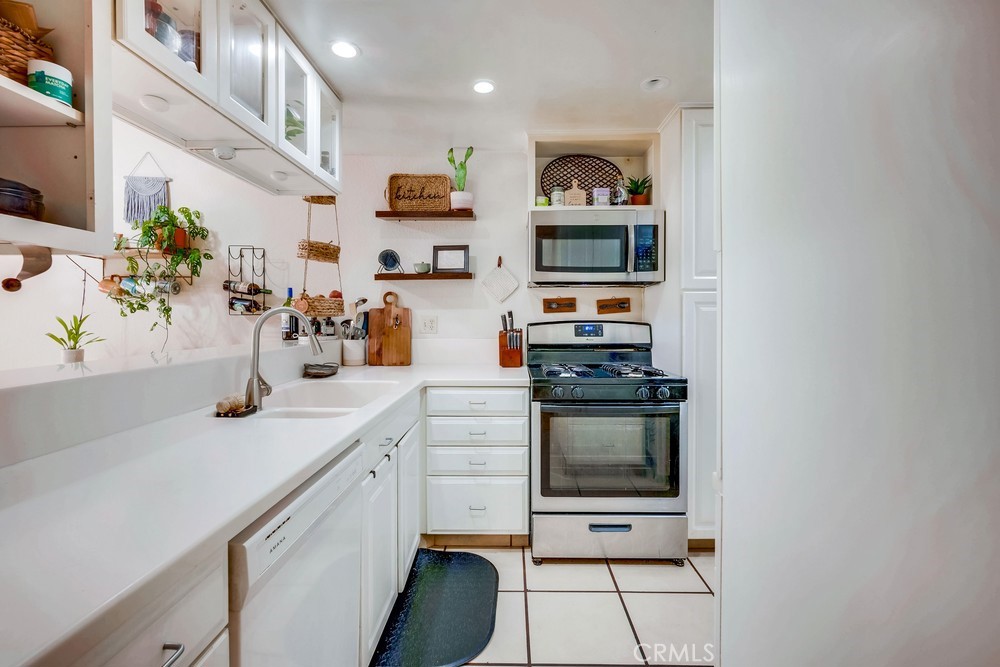 930 Countryside Street Hemet, CA 92545 - Photo 26 of 45 a kitchen with stainless steel appliances granite countertop a sink and cabinets