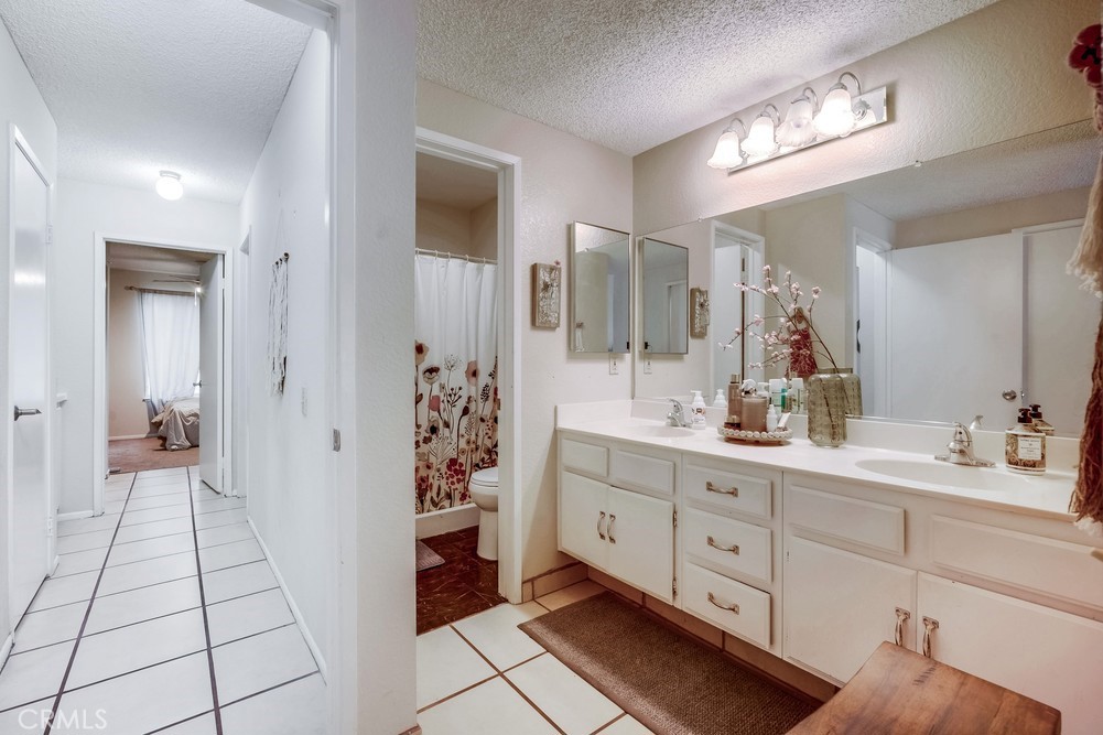 930 Countryside Street Hemet, CA 92545 - Photo 30 of 45 a spacious bathroom with a double vanity sink and a mirror