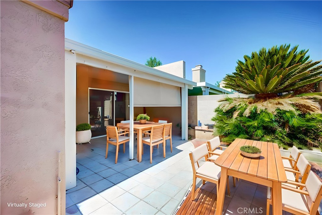 930 Countryside Street Hemet, CA 92545 - Photo 36 of 45 a view of a patio with table and chairs with wooden floor and fence