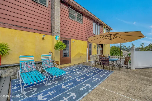 a view of staircase with railing and a chandelier