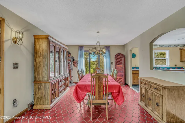 a living room with furniture and large windows