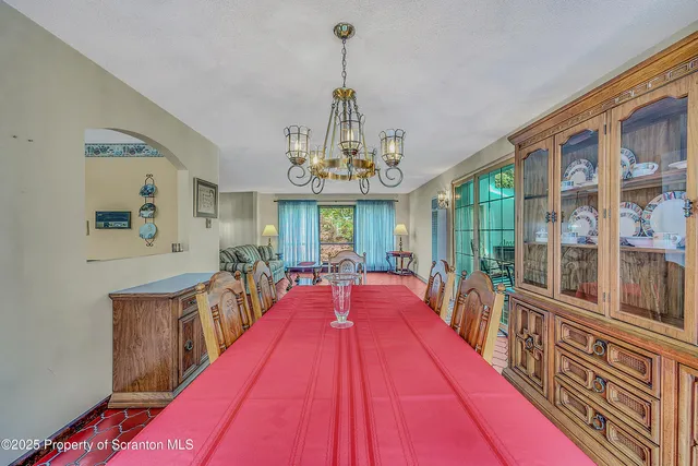 a utility room with stainless steel appliances granite countertop a sink stove and refrigerator