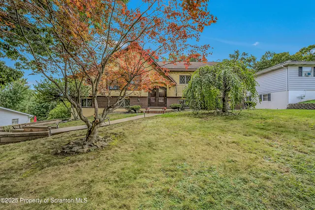 a view of a house with a yard