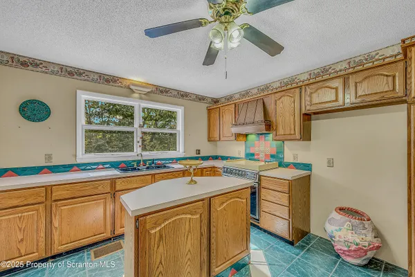 a bathroom with a granite countertop sink a mirror and shower