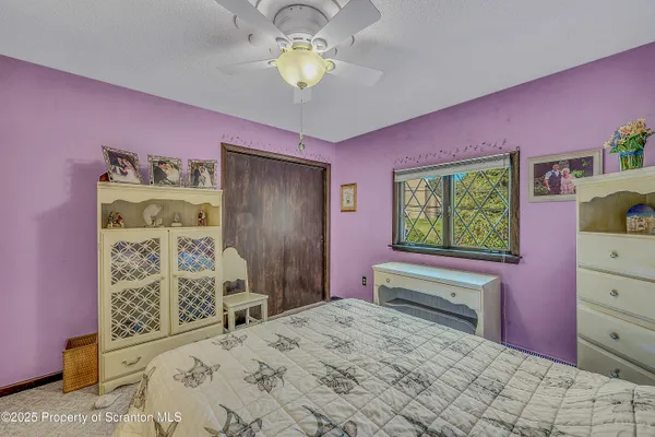 a spacious bedroom with a bed and a table in it
