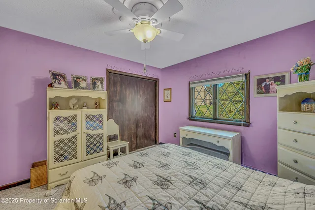 a spacious bedroom with a bed and a table in it