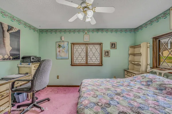 a view of a dining room with furniture and a chandelier