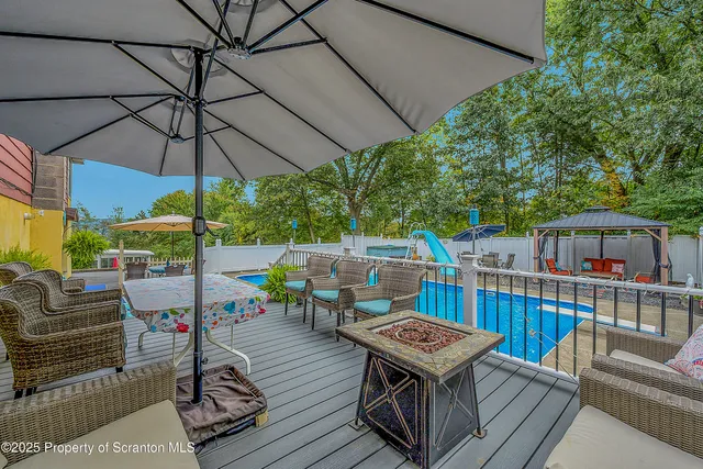 a house view with a sitting space fire pit and outdoor space