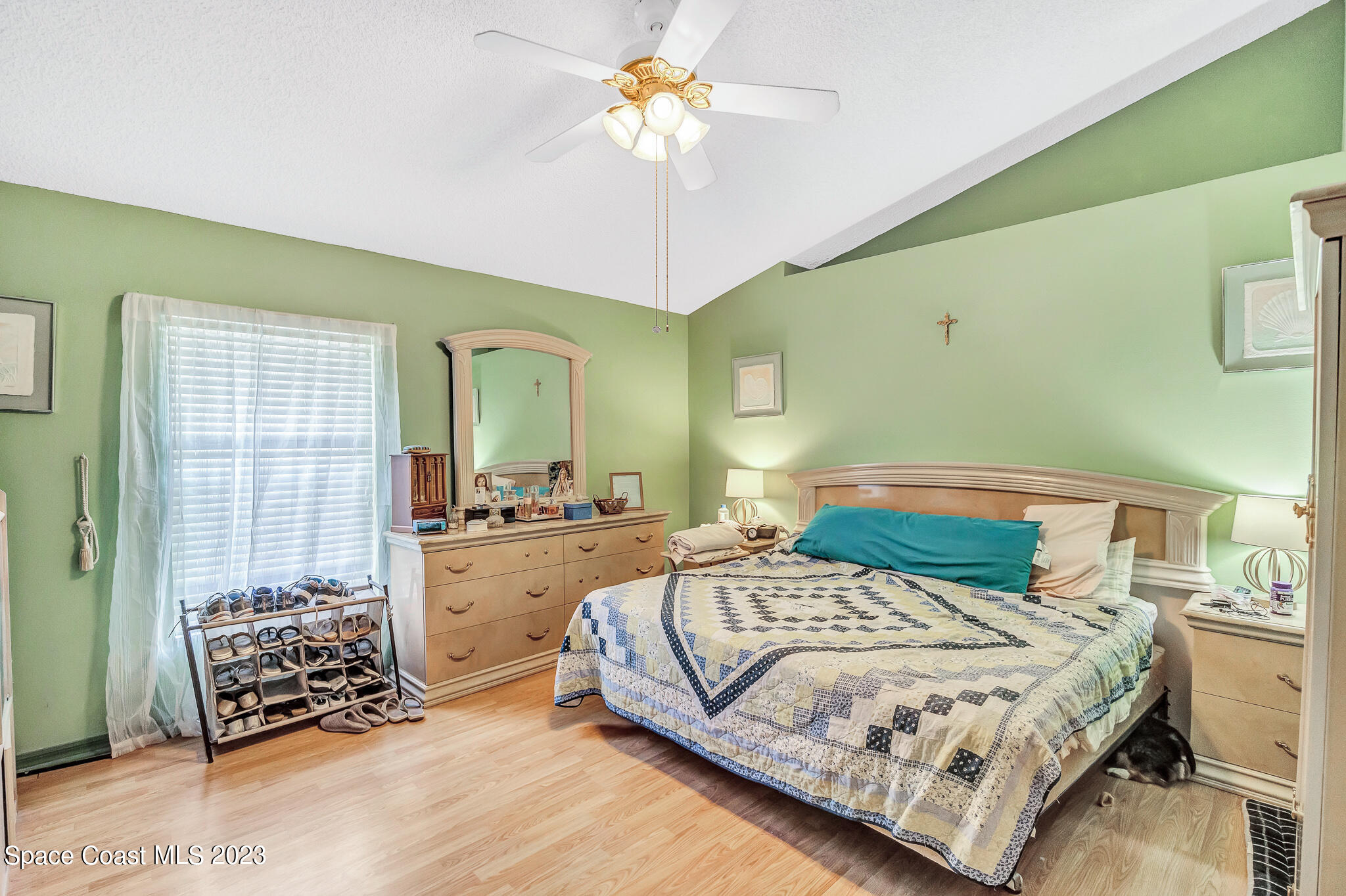 1149 White Oak Circle Melbourne, FL 32934 - Photo 12 of 55 a bedroom with a bed and a chandelier