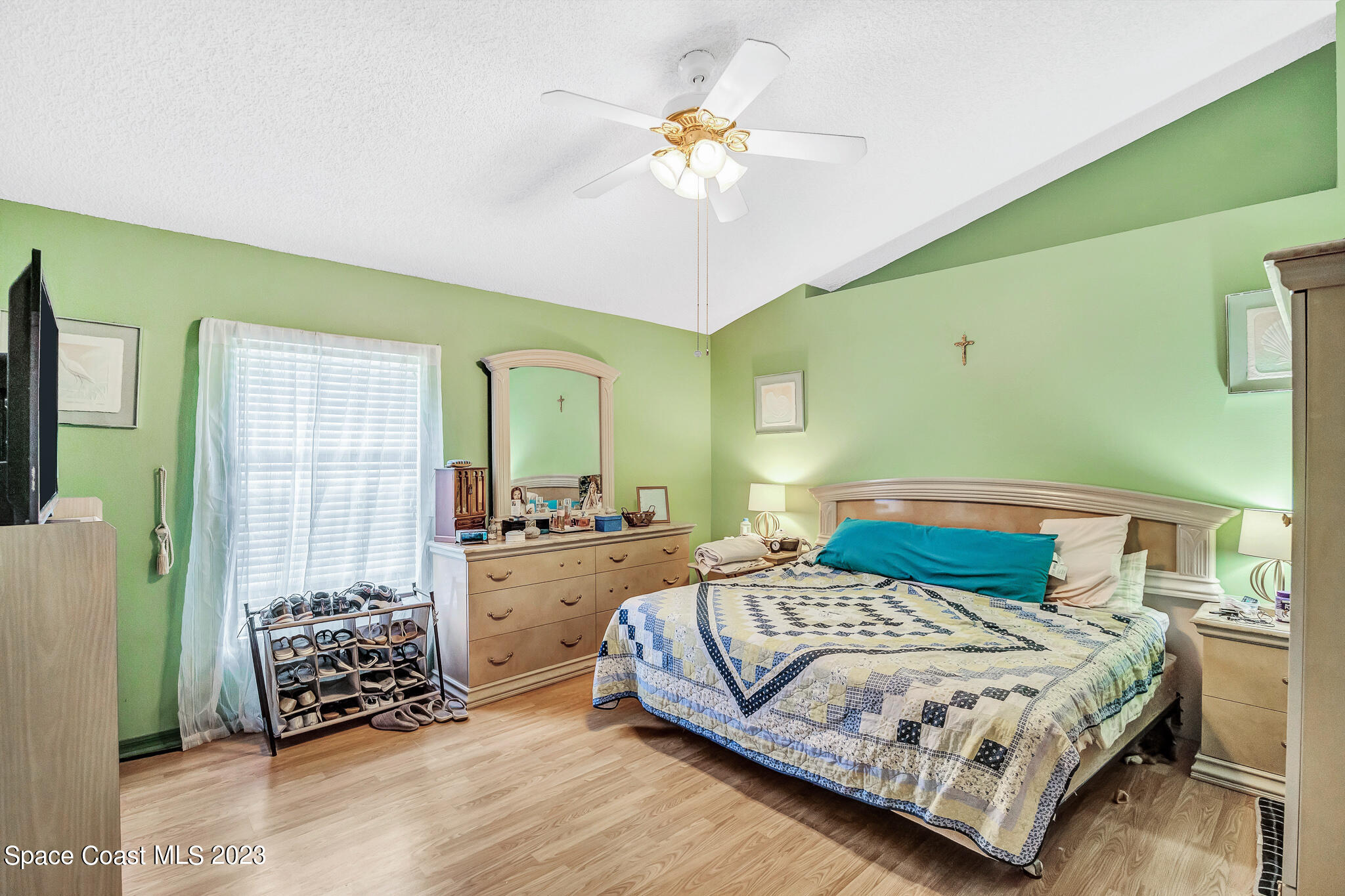 1149 White Oak Circle Melbourne, FL 32934 - Photo 13 of 55 a bedroom with a bed and a chandelier