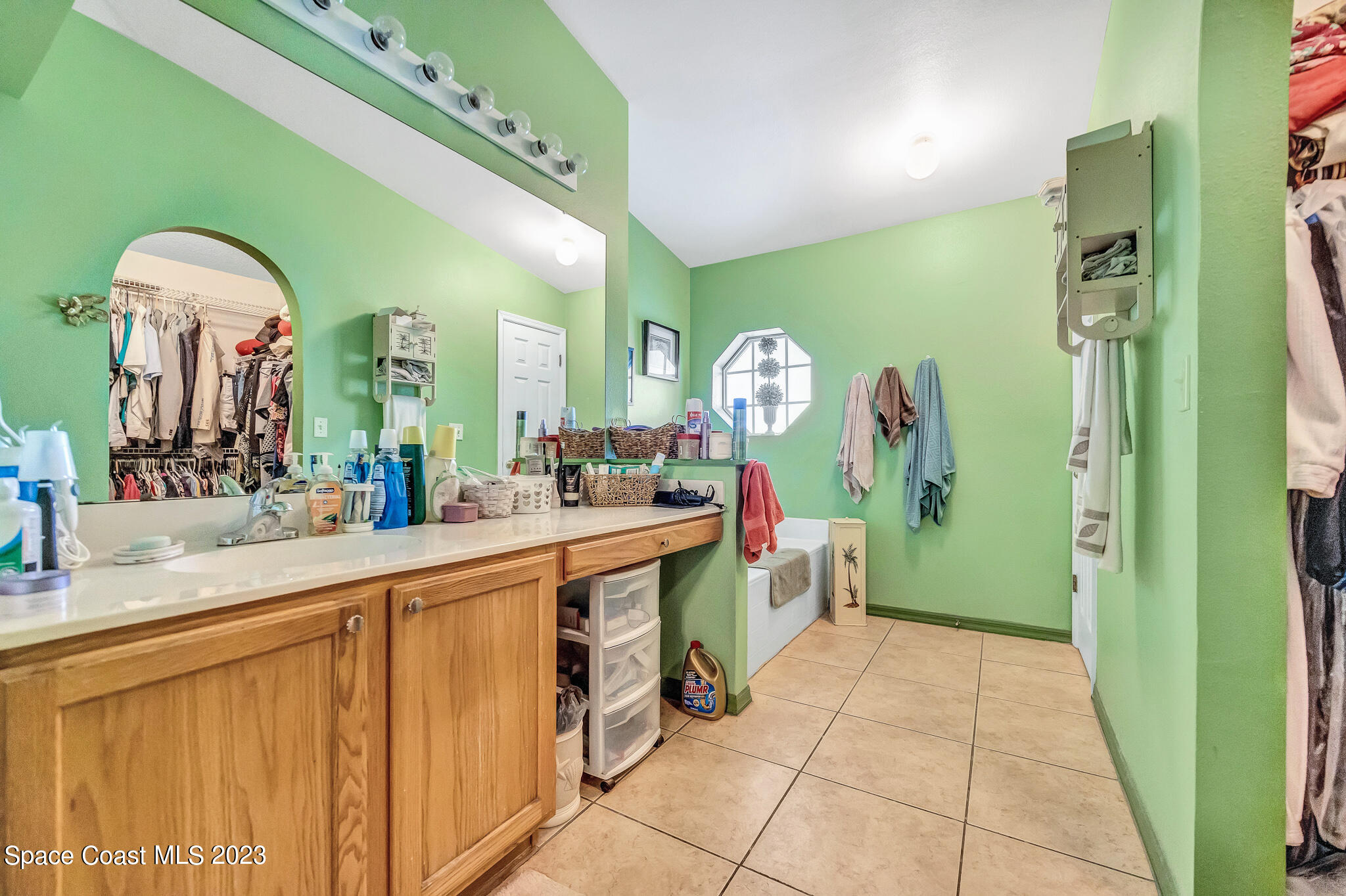 1149 White Oak Circle Melbourne, FL 32934 - Photo 15 of 55 a large bathroom with a sink a mirror and a shower