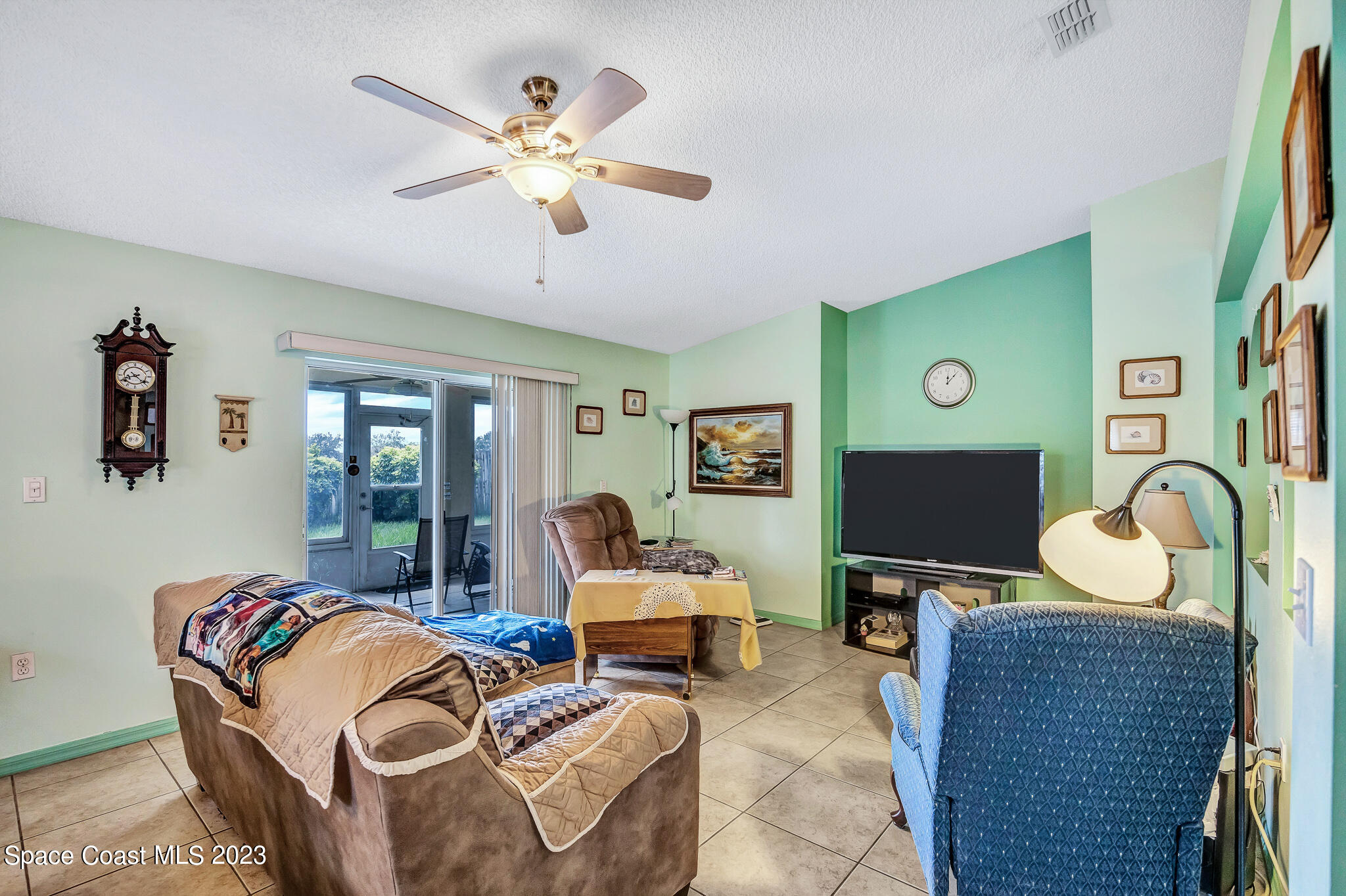 1149 White Oak Circle Melbourne, FL 32934 - Photo 23 of 55 a living room with furniture and a flat screen tv
