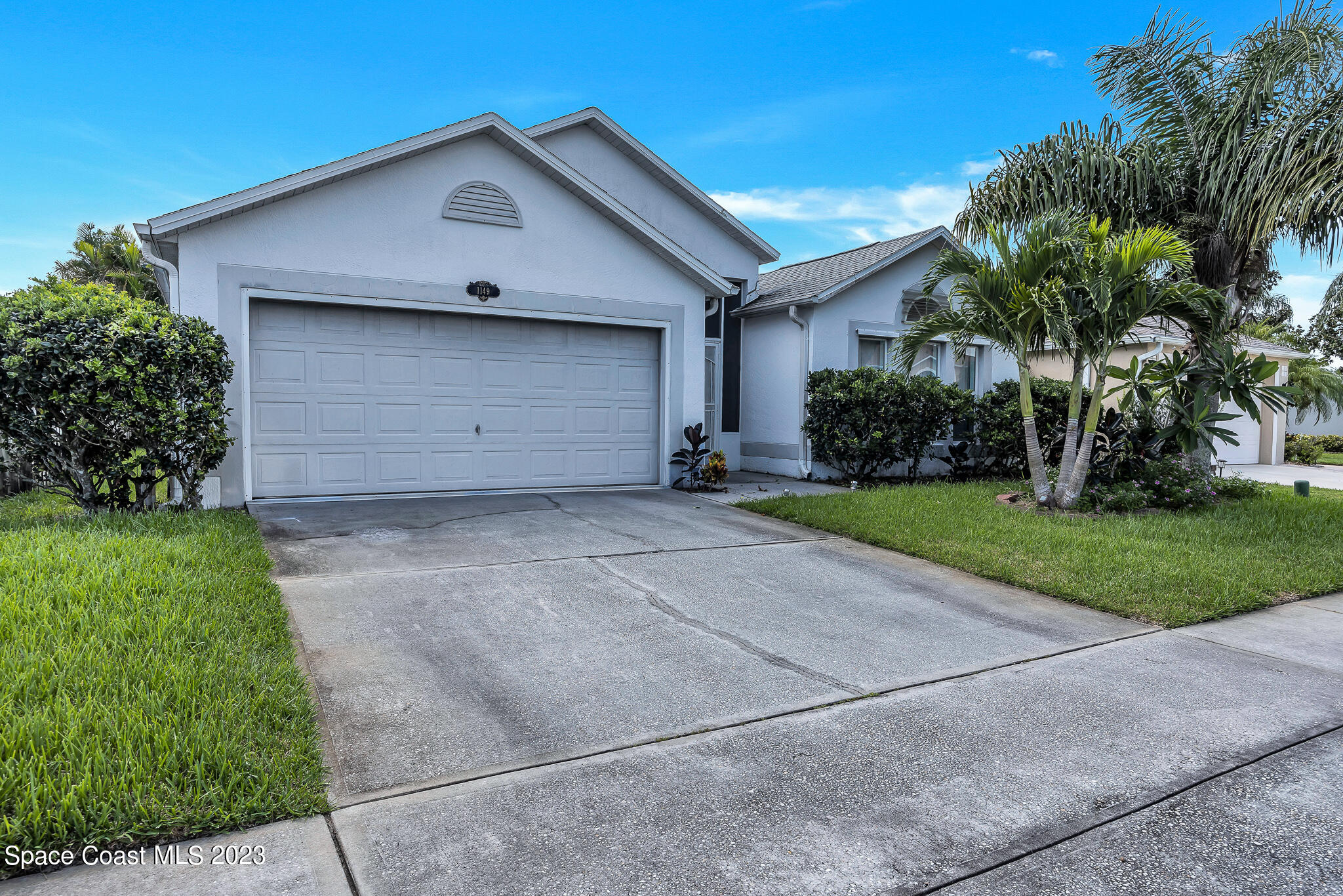 1149 White Oak Circle Melbourne, FL 32934 - Photo 3 of 55 a front view of a house with a yard and garage