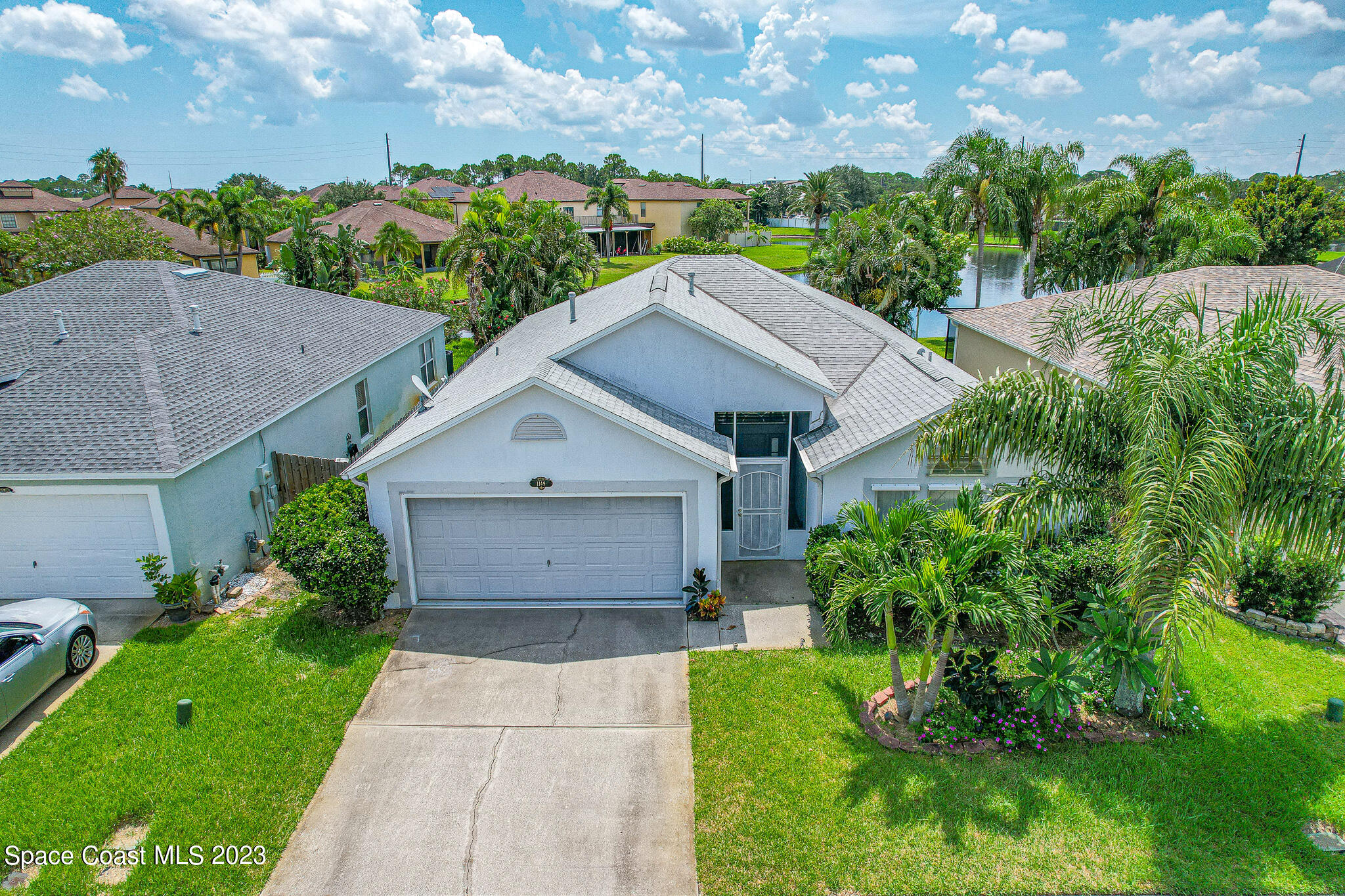 1149 White Oak Circle Melbourne, FL 32934 - Photo 40 of 55 a aerial view of a house with a yard plants and large tree