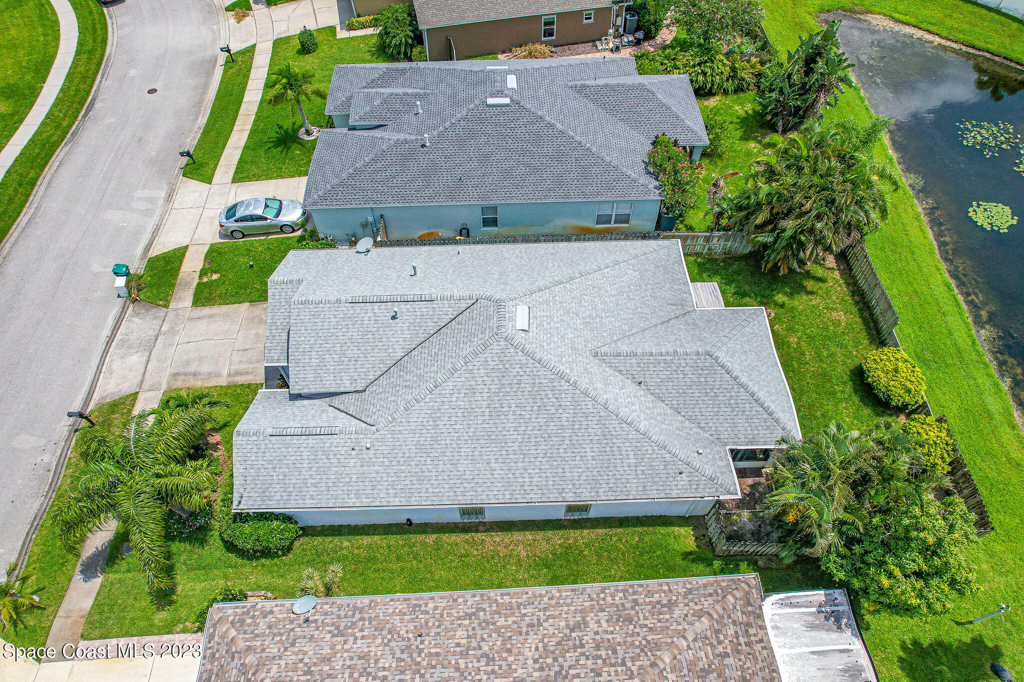 1149 White Oak Circle Melbourne, FL 32934 - Photo 42 of 55 an aerial view of a house with a garden and a yard