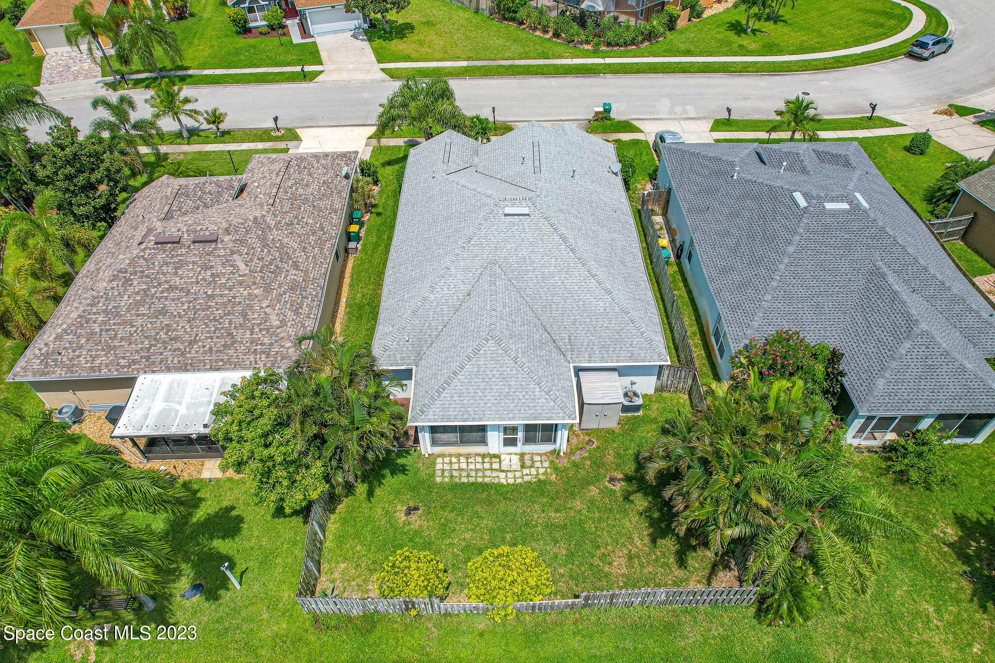 1149 White Oak Circle Melbourne, FL 32934 - Photo 43 of 55 an aerial view of a house with a garden and trees