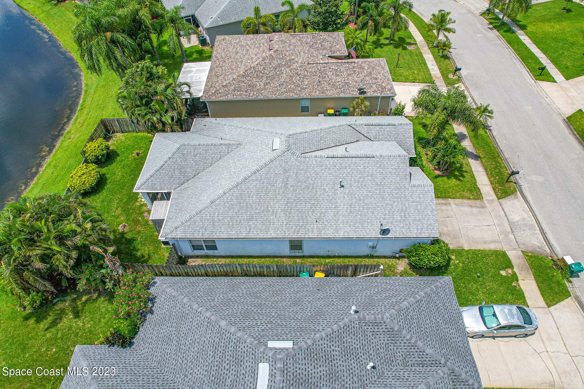 1149 White Oak Circle Melbourne, FL 32934 - Photo 44 of 55 an aerial view of a house with a garden and a yard