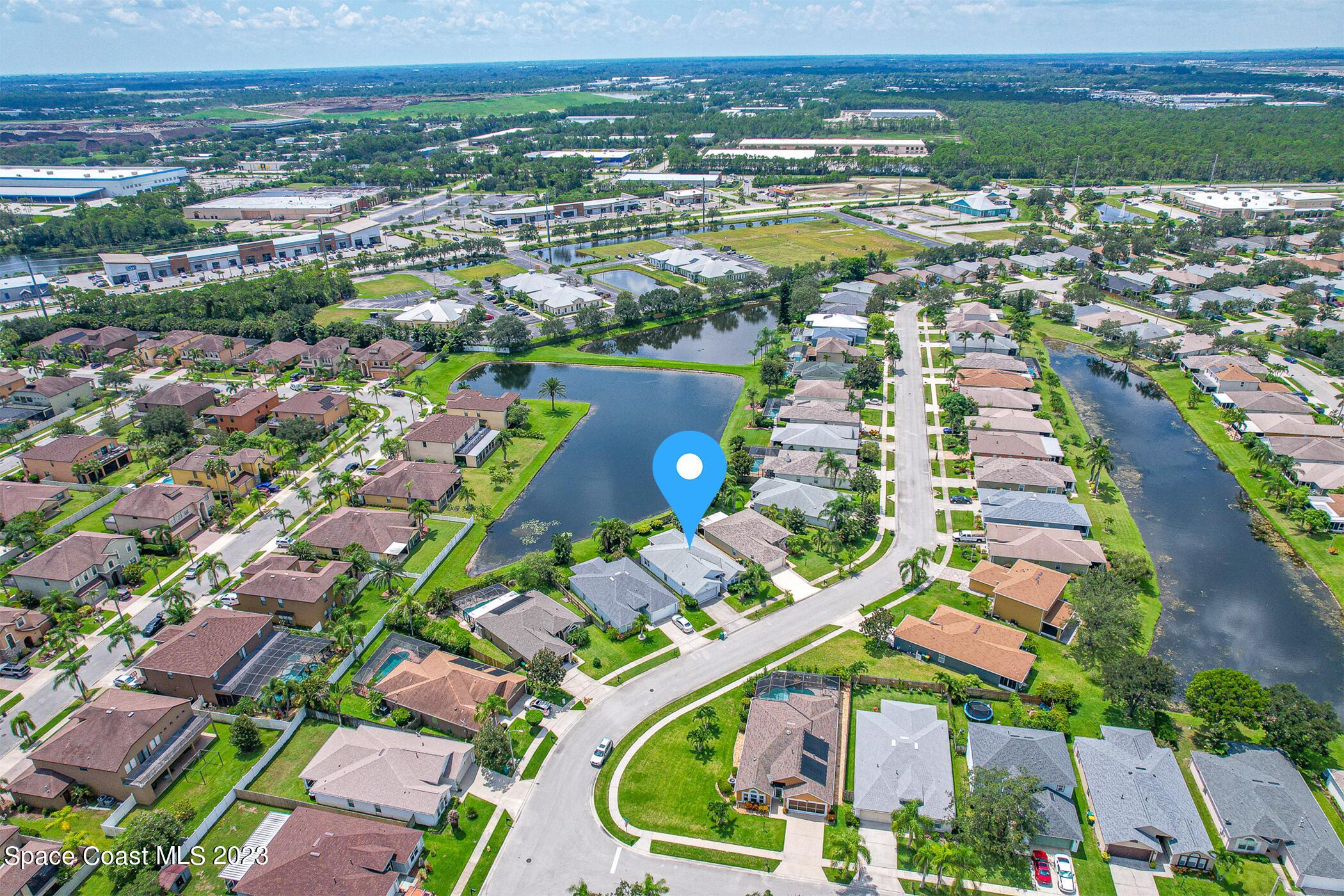 1149 White Oak Circle Melbourne, FL 32934 - Photo 53 of 55 an aerial view of residential houses with outdoor space and trees