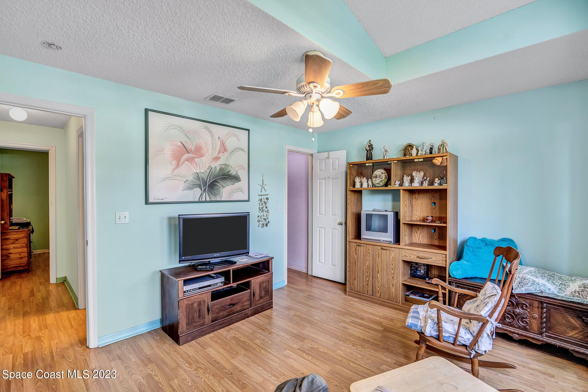 1149 White Oak Circle Melbourne, FL 32934 - Photo 8 of 55 a living room with furniture and a flat screen tv