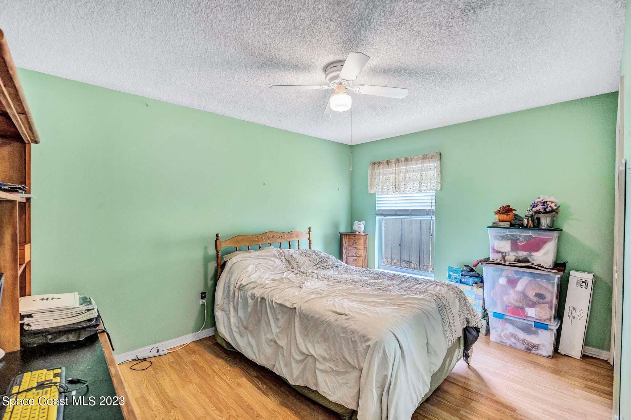 1149 White Oak Circle Melbourne, FL 32934 - Photo 9 of 55 a bedroom with a bed and wooden floor
