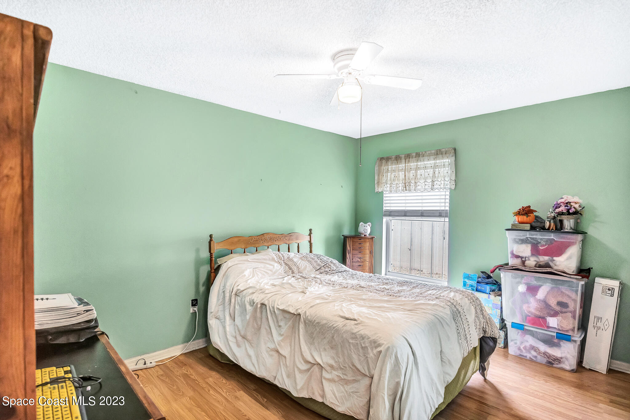 1149 White Oak Circle Melbourne, FL 32934 - Photo 10 of 55 a bedroom with a bed and wooden floor