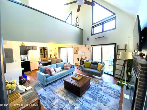 a living room with furniture a rug and a flat screen tv