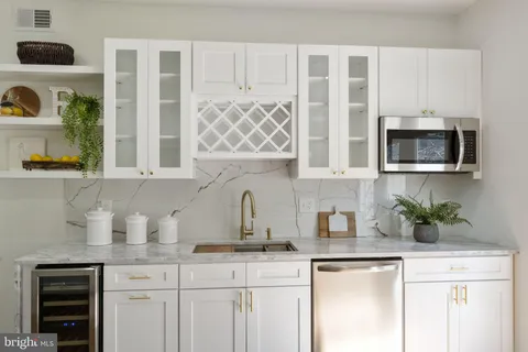 a kitchen with stainless steel appliances granite countertop a sink a microwave and cabinets
