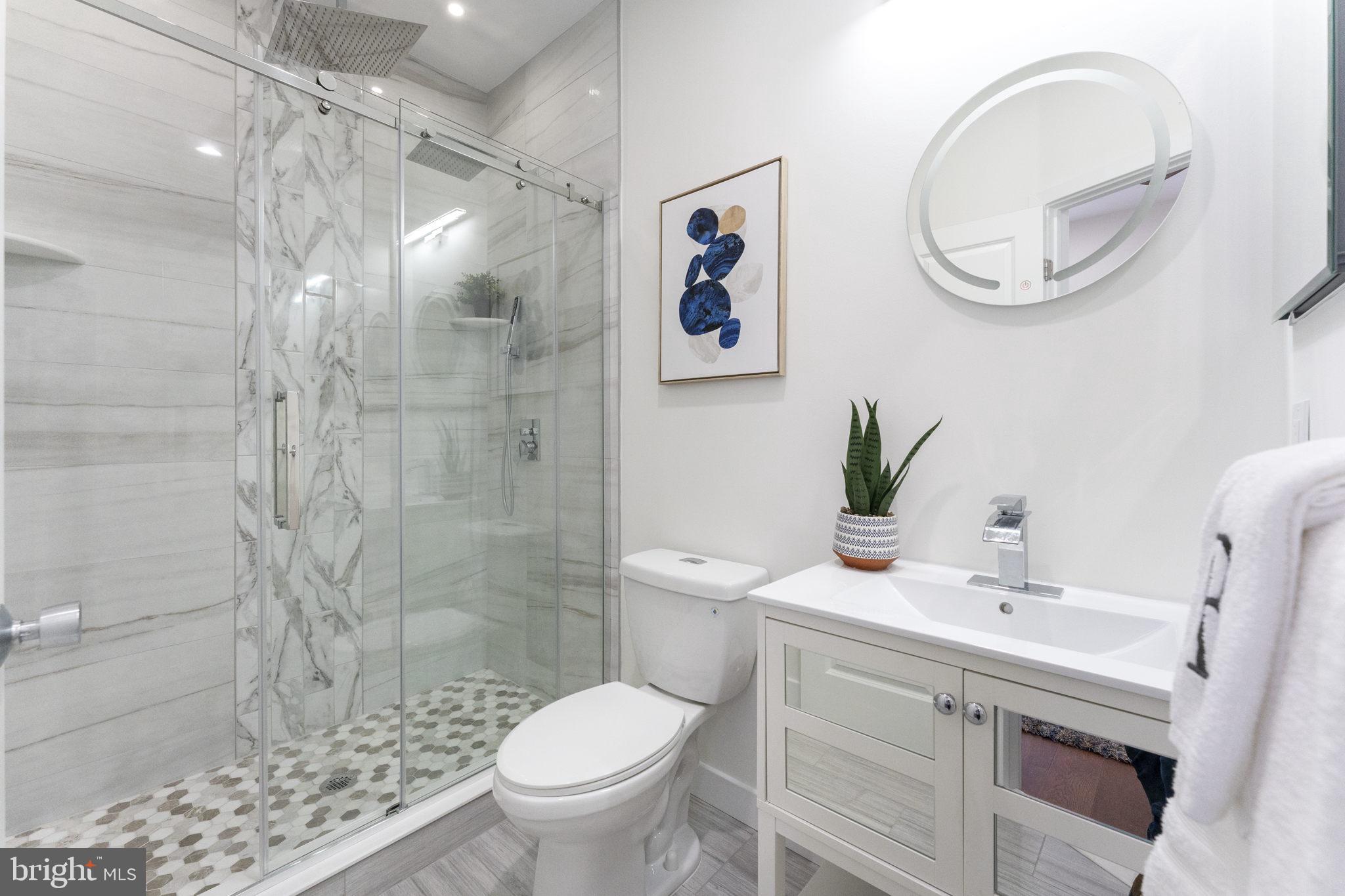 2030 Tasker Street Philadelphia, PA 19145 - Photo 19 of 29 a bathroom with a sink a toilet and a mirror