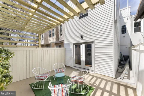 a view of a patio with table and chairs and potted plants