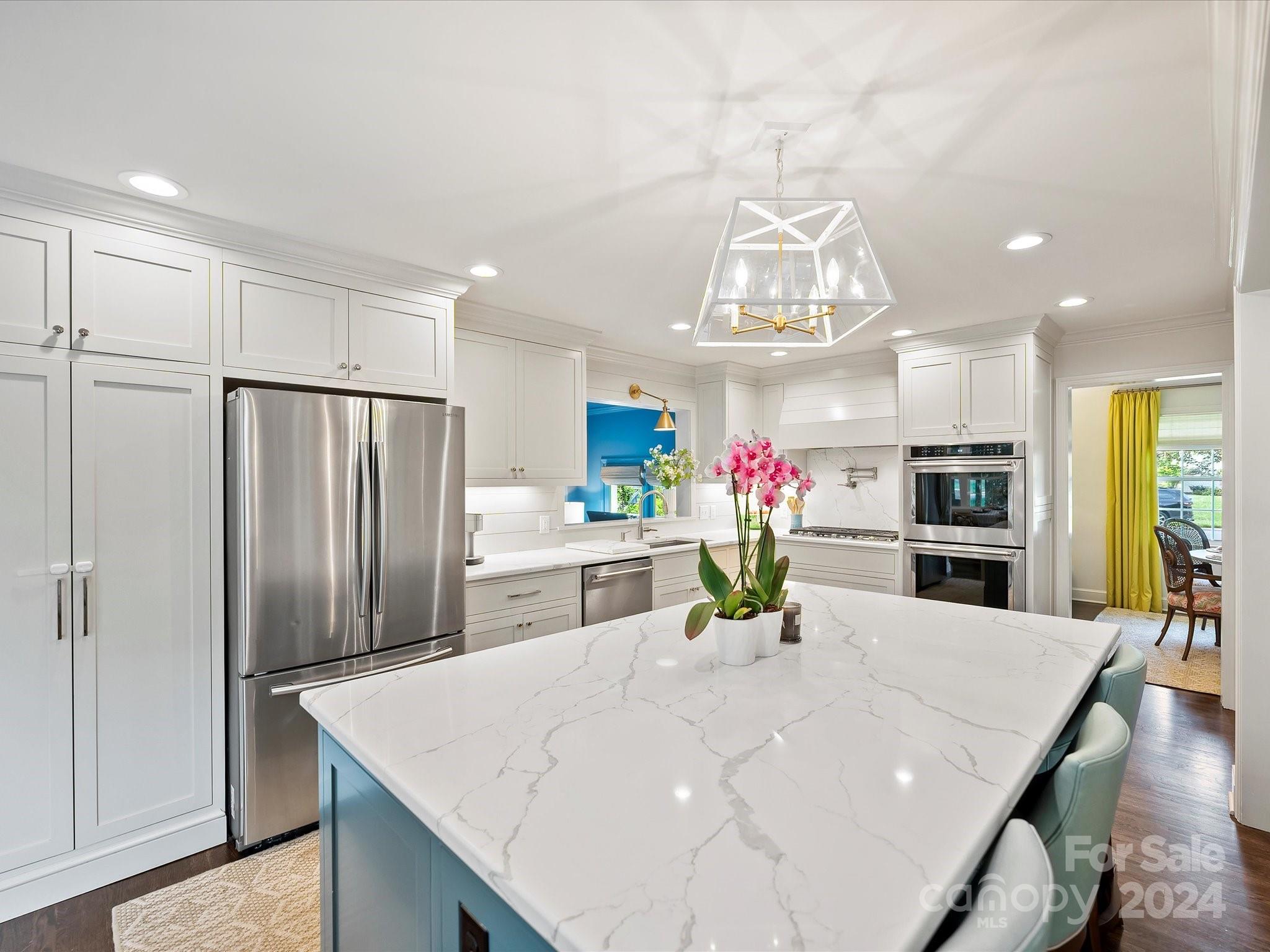 3401 Eastburn Road Charlotte, NC 28210 - Photo 14 of 43 a kitchen with stainless steel appliances a dining table chairs refrigerator and kitchen view
