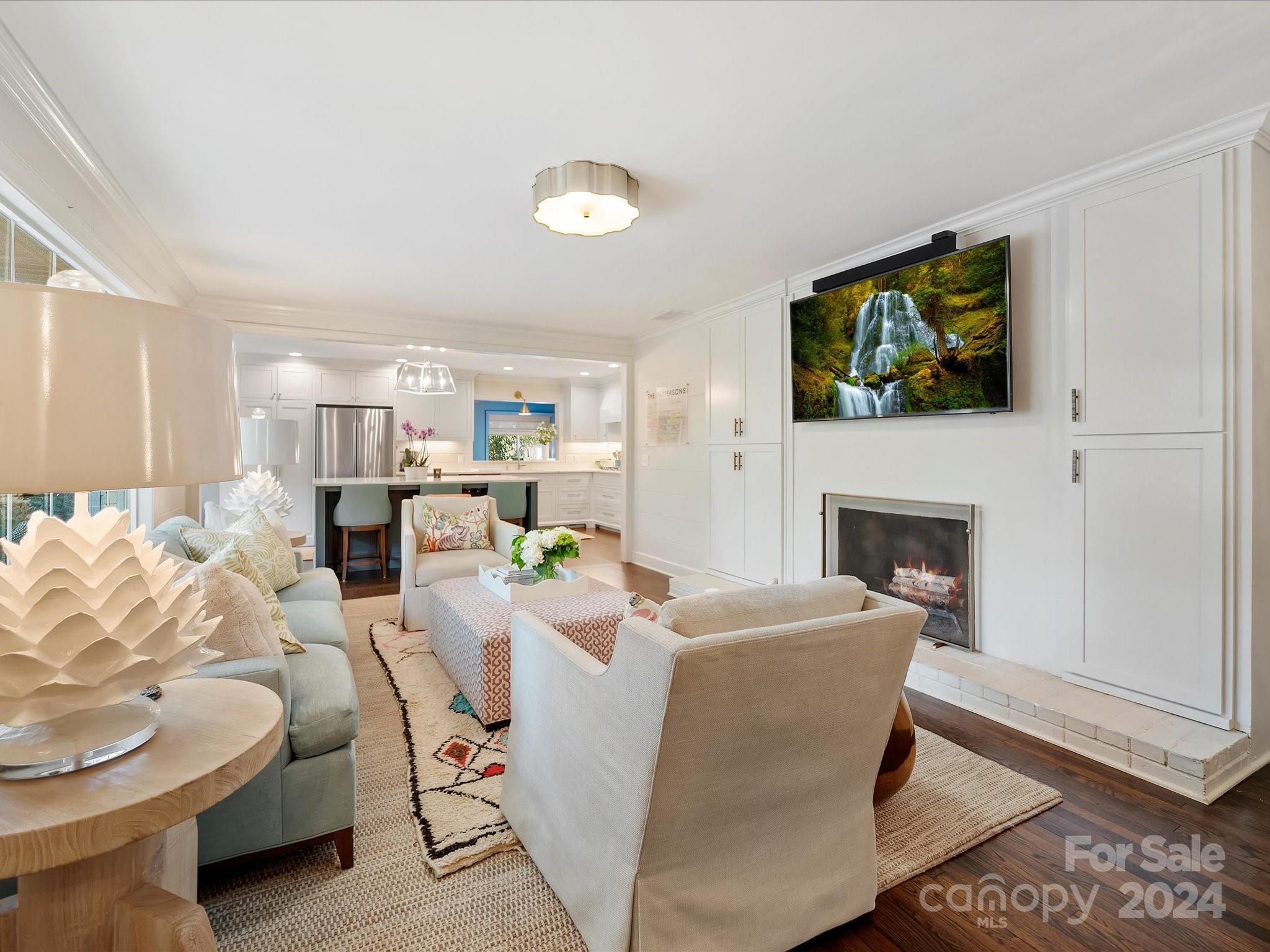 3401 Eastburn Road Charlotte, NC 28210 - Photo 19 of 43 a living room with furniture a fireplace and a flat screen tv