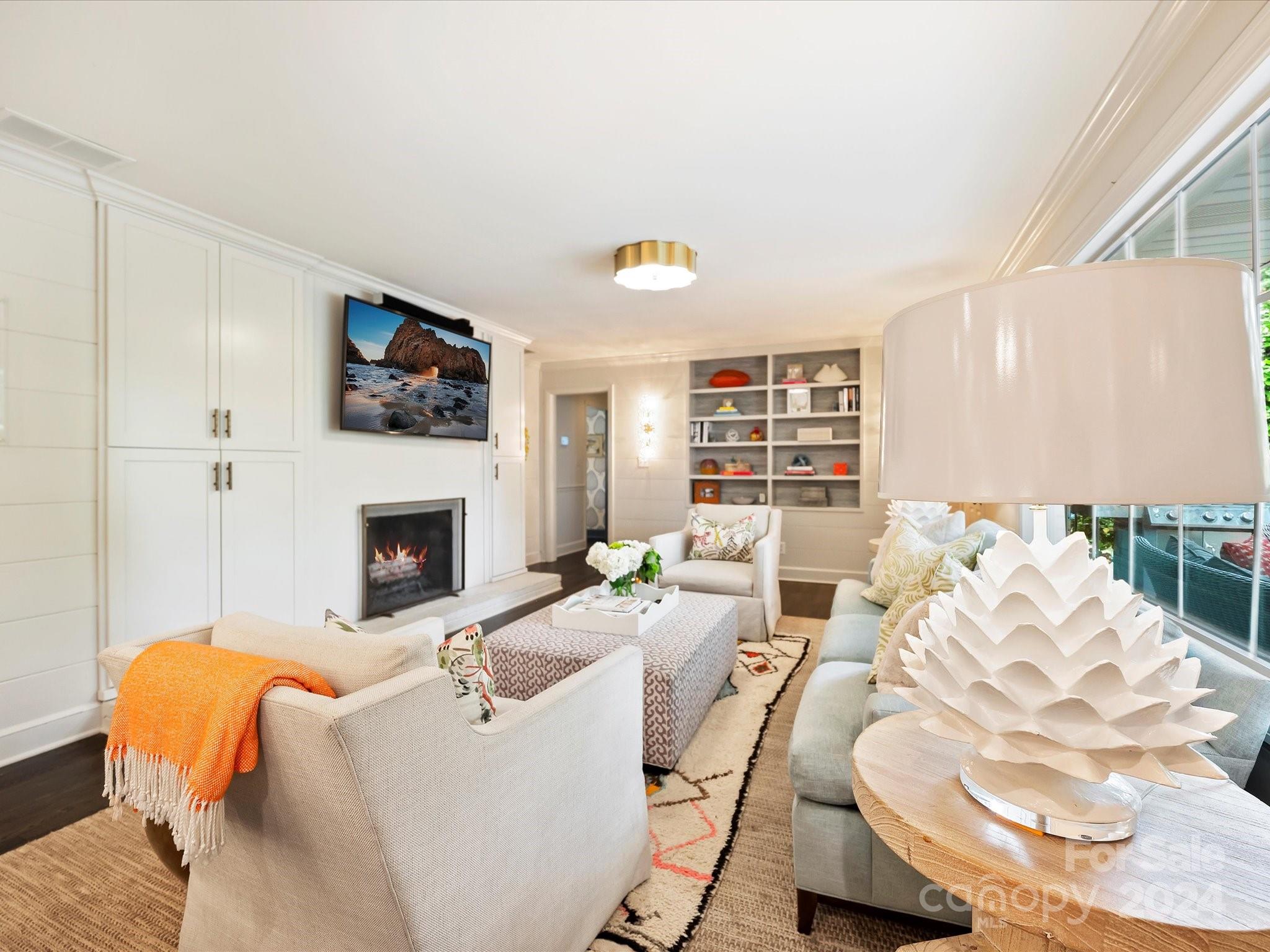 3401 Eastburn Road Charlotte, NC 28210 - Photo 21 of 43 a living room with furniture fireplace and a flat screen tv