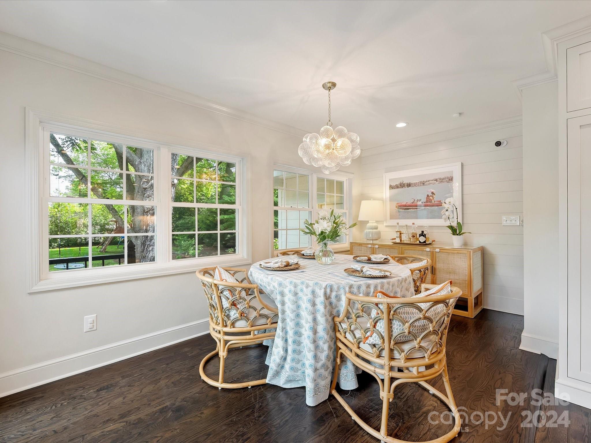 3401 Eastburn Road Charlotte, NC 28210 - Photo 22 of 43 a view of a dining room with furniture a chandelier and wooden floor