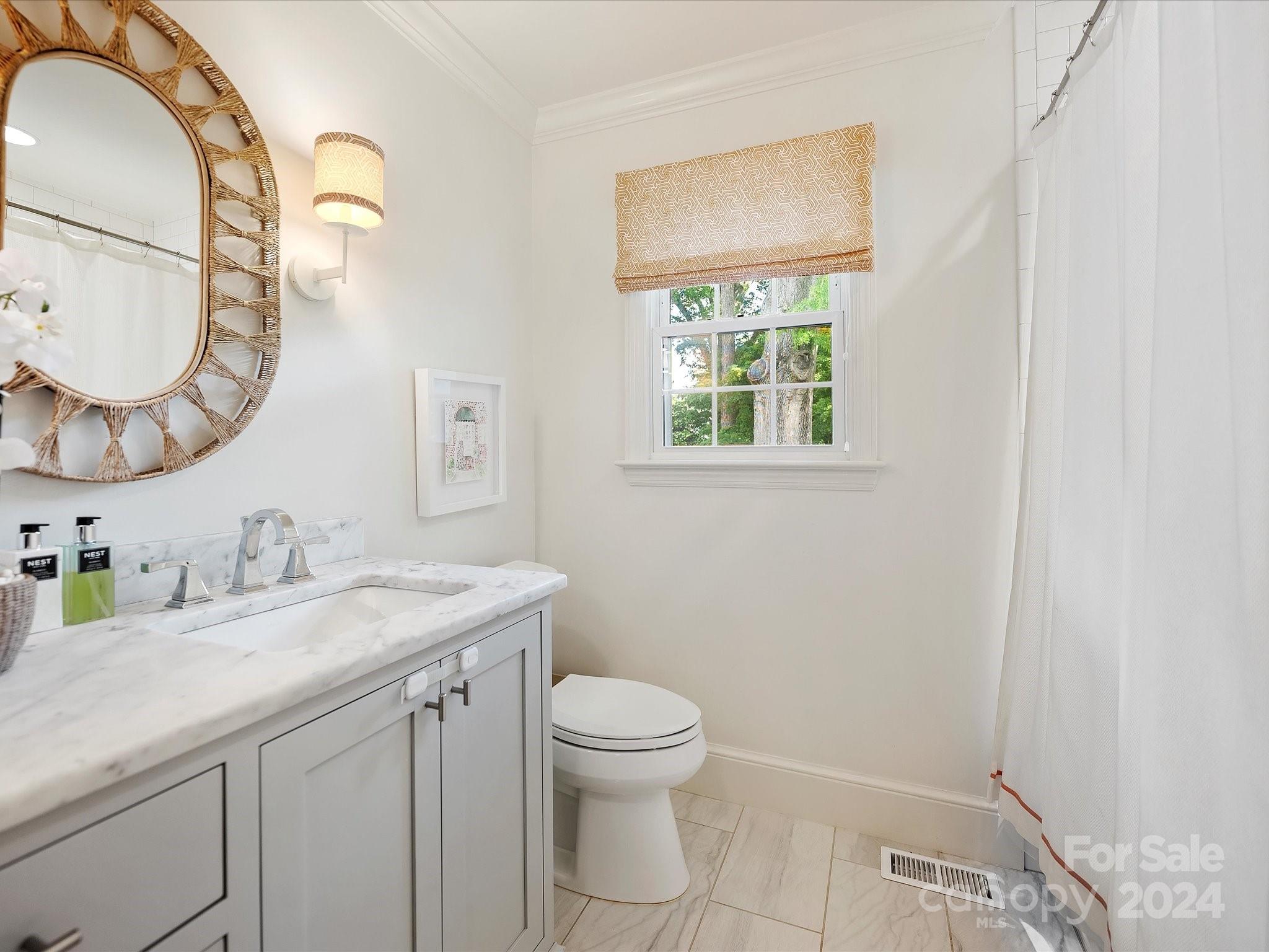 3401 Eastburn Road Charlotte, NC 28210 - Photo 33 of 43 a bathroom with a granite countertop sink a toilet and a mirror