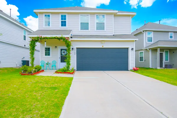 a front view of a house with a yard and garage
