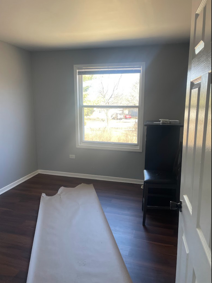 1221 Springdale Circle Naperville, IL 60564 - Photo 6 of 13 an empty room with wooden floor and windows