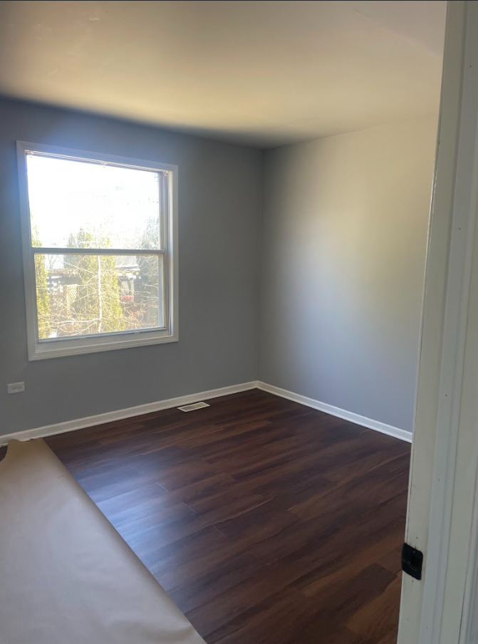 1221 Springdale Circle Naperville, IL 60564 - Photo 7 of 13 an empty room with wooden floor and windows
