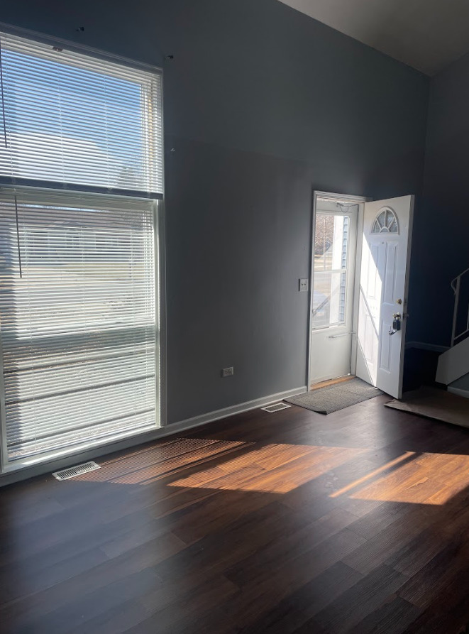 1221 Springdale Circle Naperville, IL 60564 - Photo 9 of 13 a view of empty room with wooden floor and fan