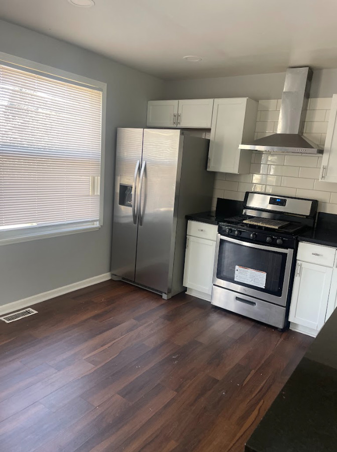 1221 Springdale Circle Naperville, IL 60564 - Photo 10 of 13 a kitchen with wooden floors and stainless steel appliances