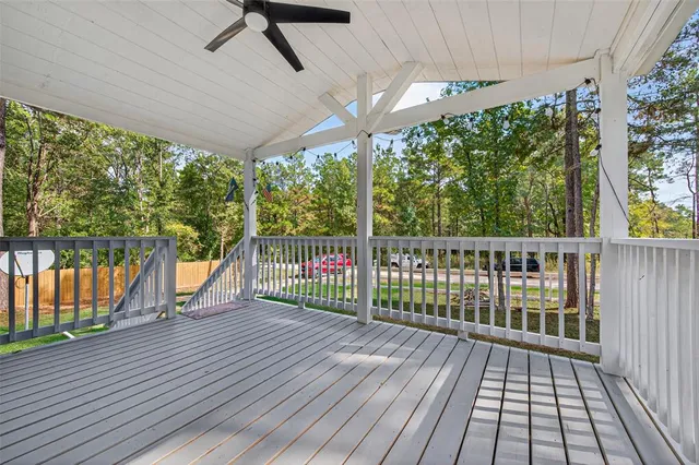 a kitchen with stainless steel appliances a refrigerator a sink dishwasher a stove and white cabinets with wooden floor