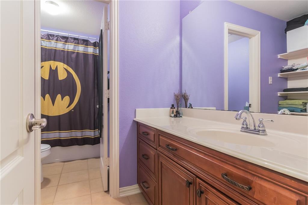 252 Pond View Pass Buda, TX 78610 - Photo 23 of 37 Bathroom with vanity and light tile patterned flooring