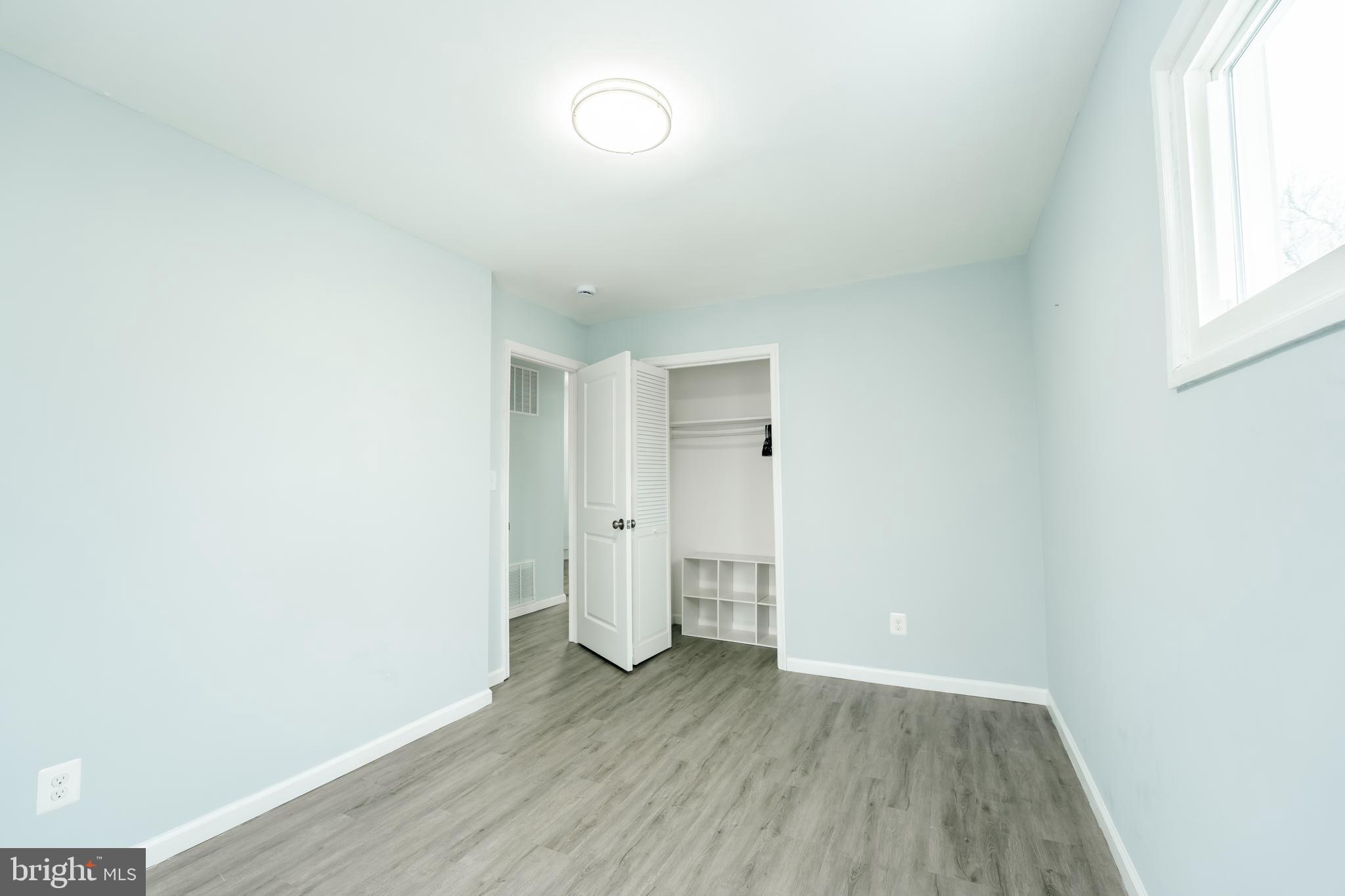 3410 Embry Street Silver Spring, MD 20902 - Photo 18 of 28 an empty room with wooden floor and windows