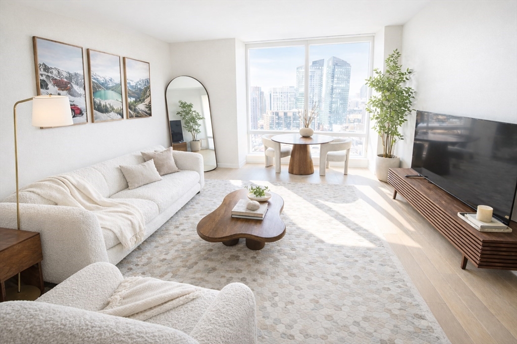 1 Franklin Street, Unit 2514 Boston, MA 02110 - Photo 1 of 11 a living room with furniture and a fireplace