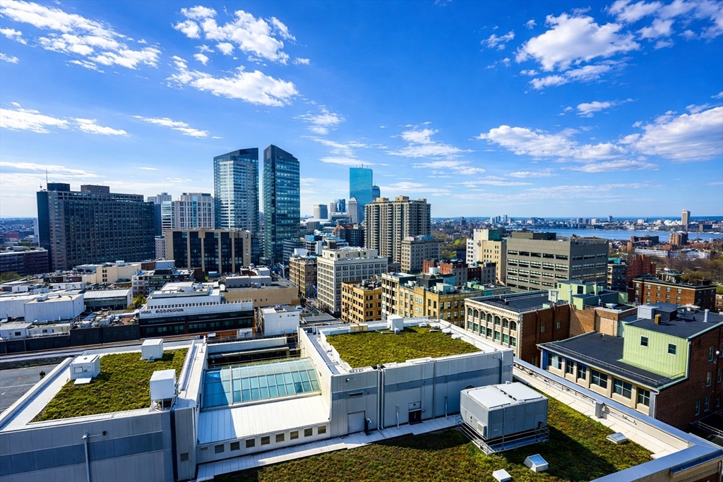 1 Franklin Street, Unit 2514 Boston, MA 02110 - Photo 11 of 11 a view of a rooftop deck with couch and chairs