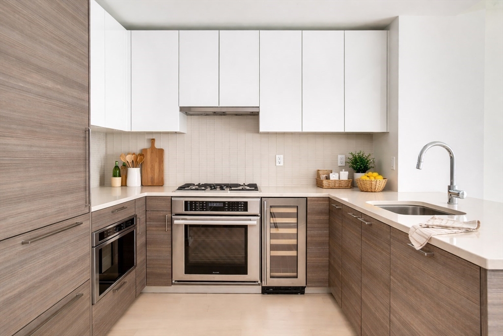 1 Franklin Street, Unit 2514 Boston, MA 02110 - Photo 5 of 11 a kitchen with cabinets appliances and a sink