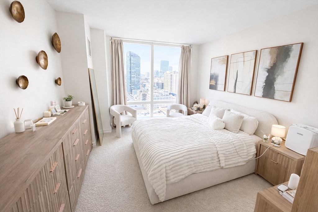 1 Franklin Street, Unit 2514 Boston, MA 02110 - Photo 6 of 11 a bedroom with a bed and a large window