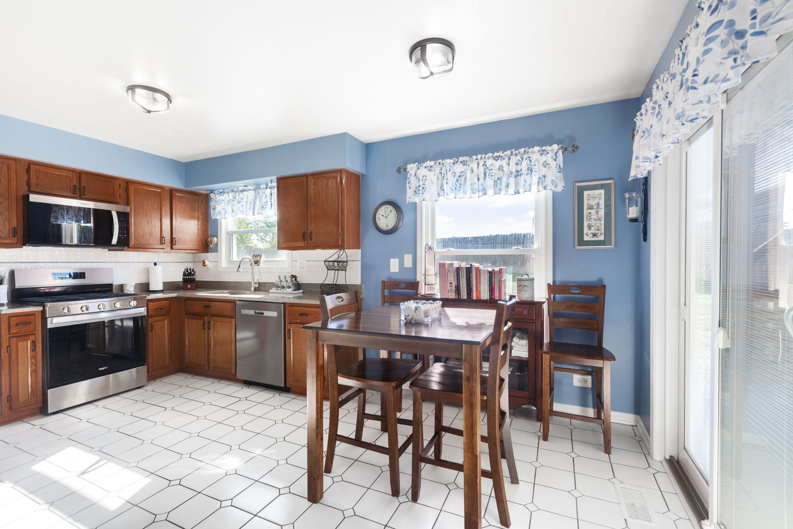 9 Arthur Court Streamwood, IL 60107 - Photo 4 of 21 a kitchen with stainless steel appliances granite countertop a stove top oven a sink a dining table and chairs