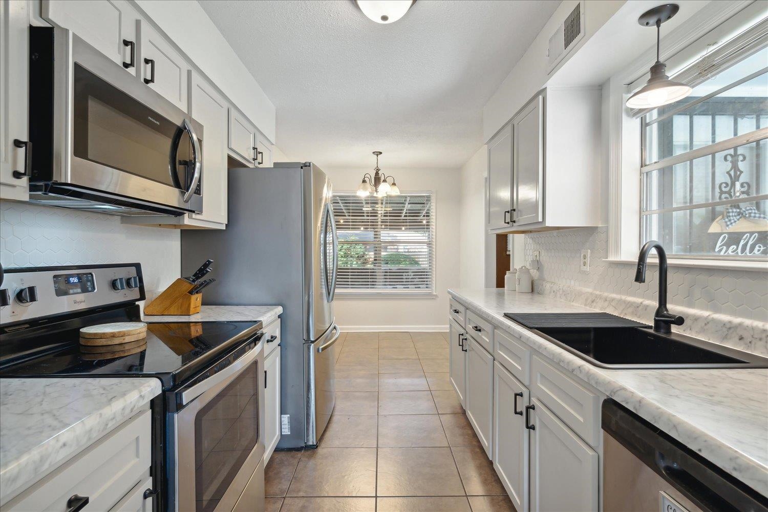 3093 Altruria Road Bartlett, TN 38134 - Photo 12 of 26 a kitchen that has a sink and a stove top oven