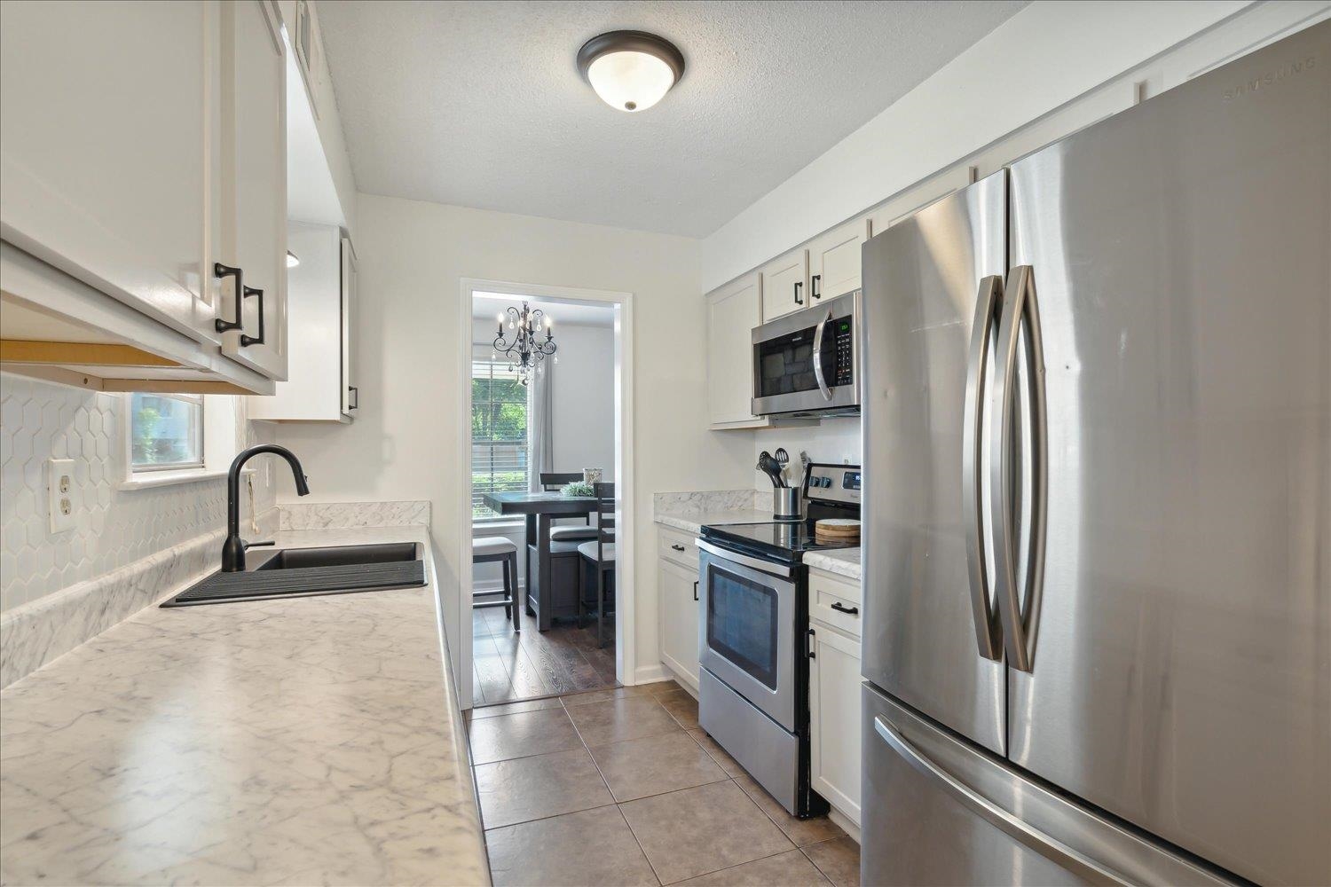 3093 Altruria Road Bartlett, TN 38134 - Photo 13 of 26 a kitchen with stainless steel appliances granite countertop a refrigerator and a sink